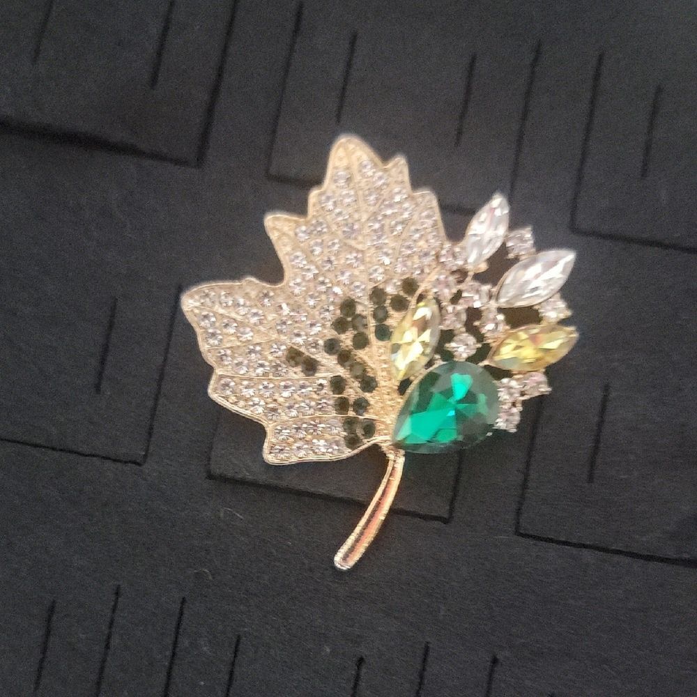 Elegant Gold Tone Leaf Brooch with Green and Silver Accents